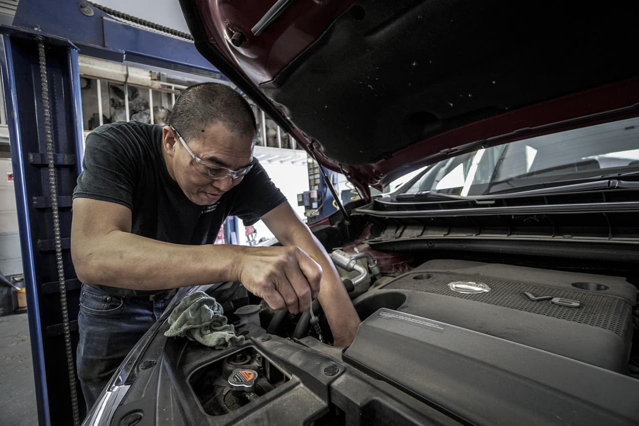 Mechanic working under the bonnet of a car